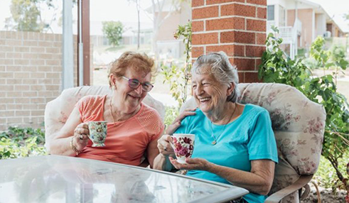 Older Australians drinking coffee together